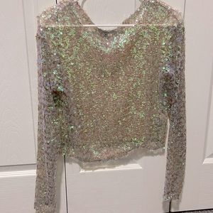 It is a full sequin top, pink in color but also has iridescent tones